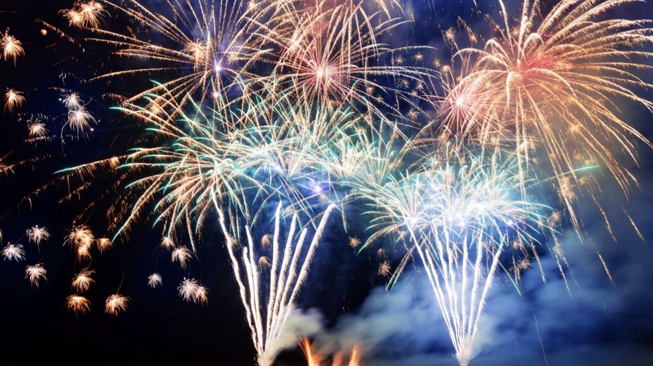 夜空中多層次、五彩繽紛的煙火齊放，伴隨著白色煙霧，畫面充滿張力